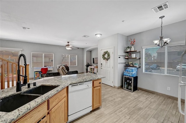 kitchen with dishwasher, a sink, a ceiling fan, decorative light fixtures, and a chandelier