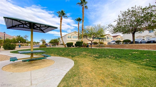 surrounding community with a residential view and a lawn