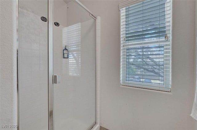 full bath featuring a shower stall
