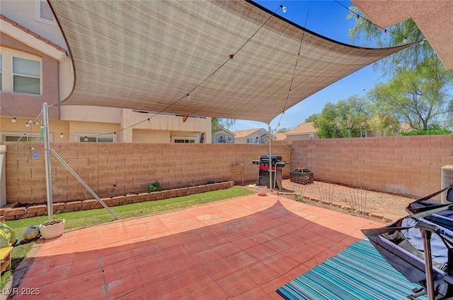 view of patio with a fenced backyard and area for grilling