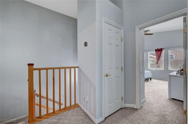 hall with carpet floors and baseboards