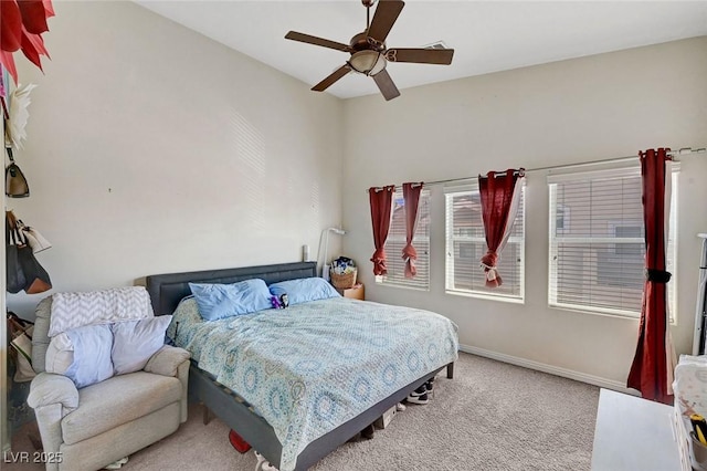 carpeted bedroom with baseboards and ceiling fan