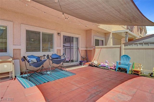 view of patio / terrace featuring fence