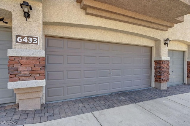 garage with decorative driveway