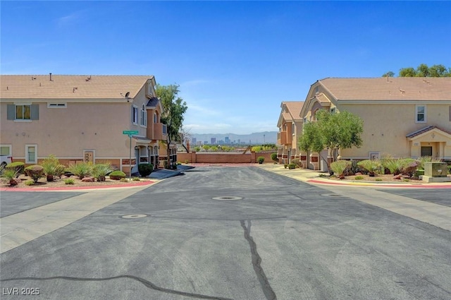 view of asphalt street featuring a residential view