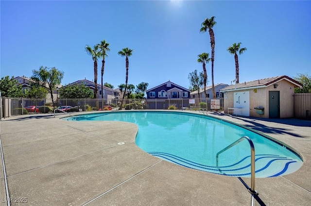 community pool with fence, a residential view, and a patio area