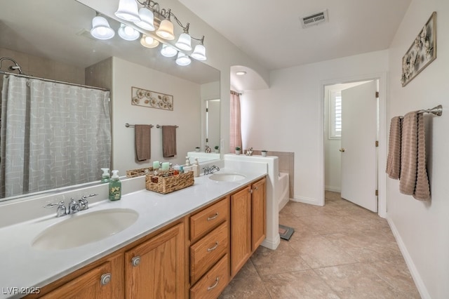 10294 Running Falls St, Las Vegas, NV 89178 - full bath with double vanity, a garden tub, baseboards, and curtained shower