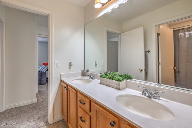 10294 Running Falls St, Las Vegas, NV 89178 - bathroom with double vanity and baseboards