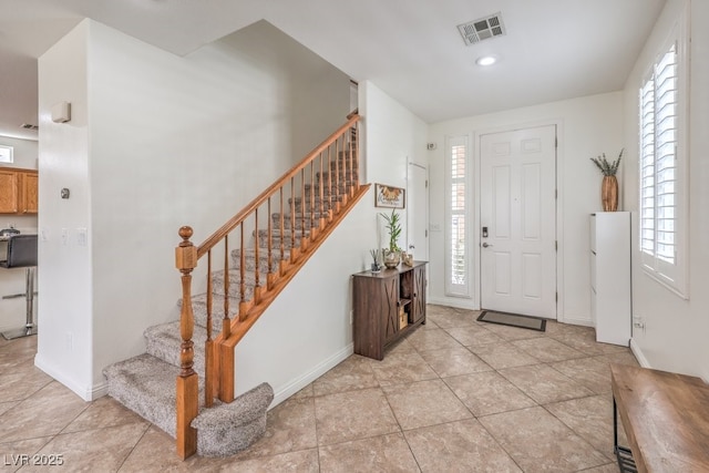 10294 Running Falls St, Las Vegas, NV 89178 - foyer with stairway, plenty of natural light, and light tile patterned flooring