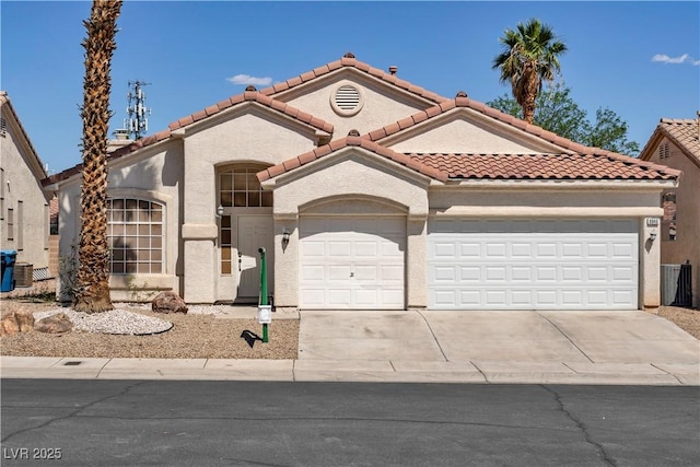 8940 Emery Lake St, Las Vegas, NV 89123 - mediterranean / spanish-style house with an attached garage, concrete driveway, a tile roof, stucco siding, and central air condition unit