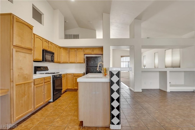 8940 Emery Lake St, Las Vegas, NV 89123 - kitchen with black appliances, light tile patterned floors, tile counters, a sink, and open floor plan