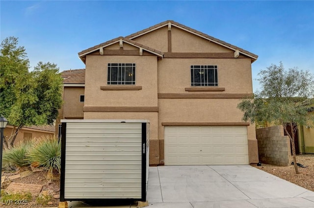 view of front of home with stucco siding, a garage, and driveway