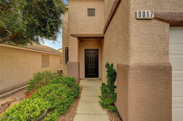 doorway to property with stucco siding