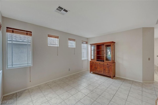 spare room with baseboards