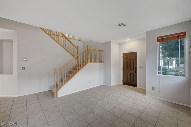 tiled foyer with stairway, baseboards, and recessed lighting