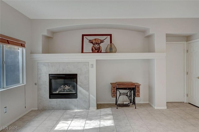 living area with a fireplace and tile patterned floors