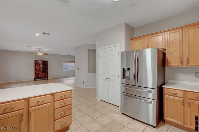 kitchen featuring stainless steel fridge, ceiling fan, light tile patterned flooring, light countertops, and open floor plan