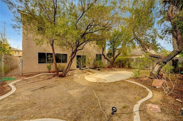 fenced backyard with a patio area