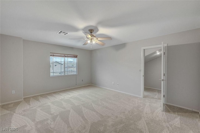 carpeted empty room with ceiling fan and baseboards