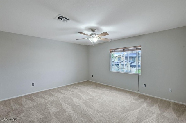 empty room with light colored carpet, ceiling fan, and baseboards