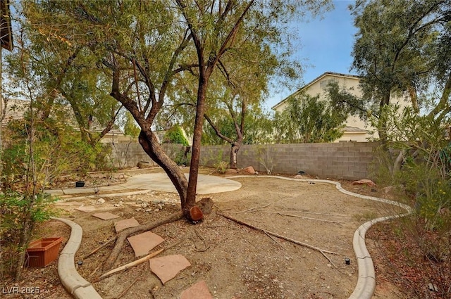 fenced backyard with a patio