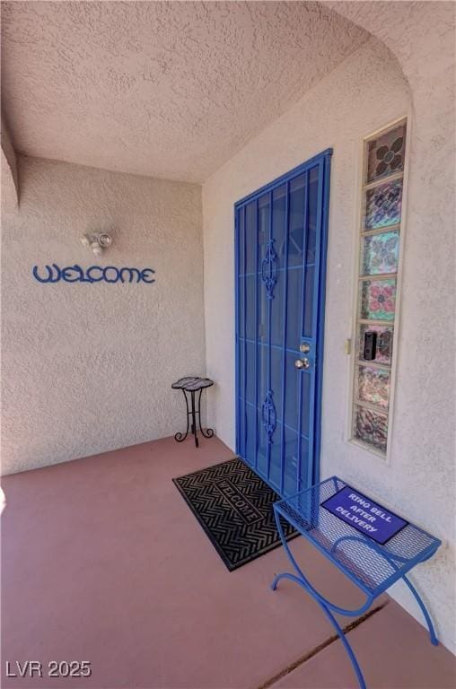 entrance to property with stucco siding
