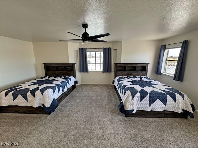 carpeted bedroom with ceiling fan, a textured ceiling, and baseboards