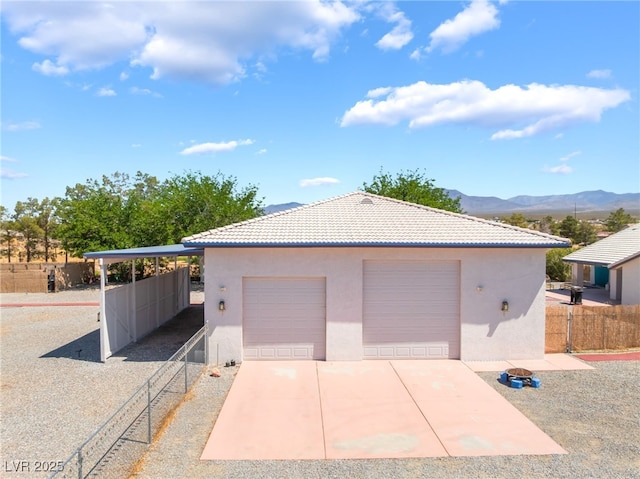 2650 Sagebrush Ave, Pahrump, NV 89048 - garage with fence, a mountain view, and a garage