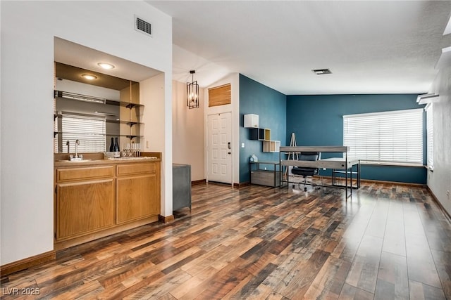 5242 Dickens Dr, Las Vegas, NV 89119 - kitchen with baseboards, visible vents, a sink, and wood finished floors