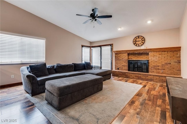 5242 Dickens Dr, Las Vegas, NV 89119 - living room with a ceiling fan, a fireplace, hardwood / wood-style floors, baseboards, and lofted ceiling