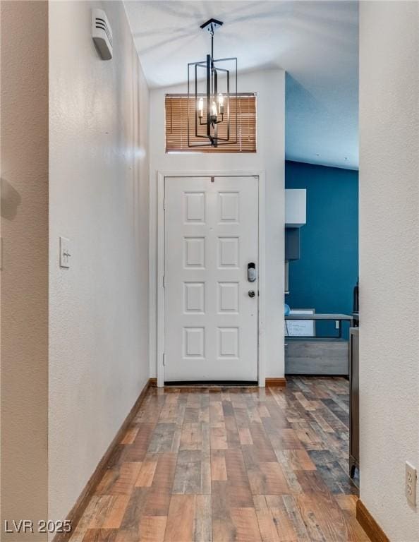 5242 Dickens Dr, Las Vegas, NV 89119 - entryway featuring baseboards, an inviting chandelier, and wood finished floors