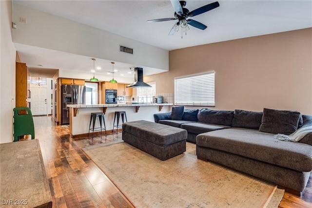 5242 Dickens Dr, Las Vegas, NV 89119 - living area with light wood-type flooring, a ceiling fan, and visible vents