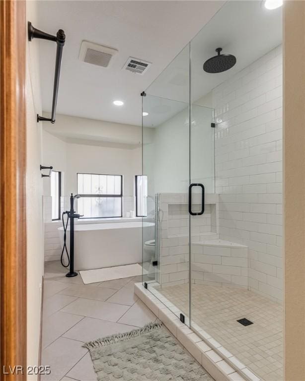 5242 Dickens Dr, Las Vegas, NV 89119 - full bathroom with visible vents, recessed lighting, tile patterned floors, a shower stall, and a soaking tub