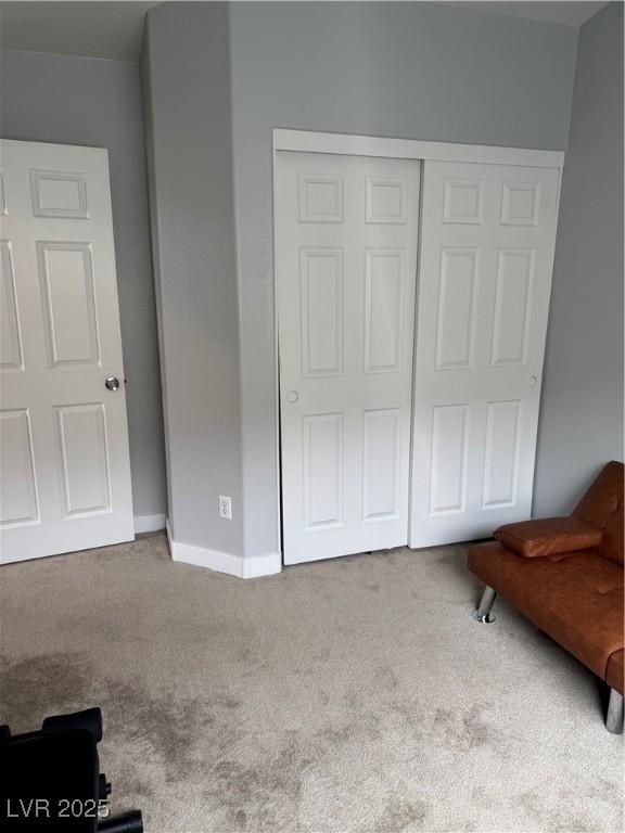 bedroom with carpet floors, a closet, and baseboards