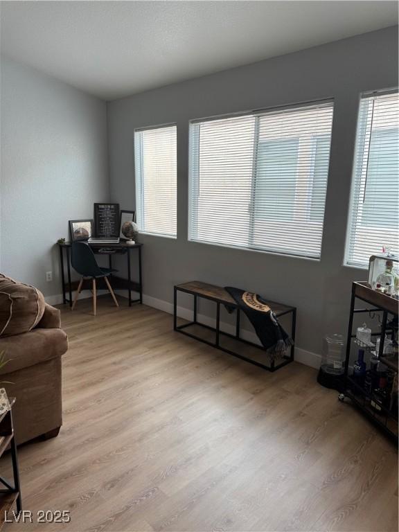 office area with light wood finished floors and baseboards