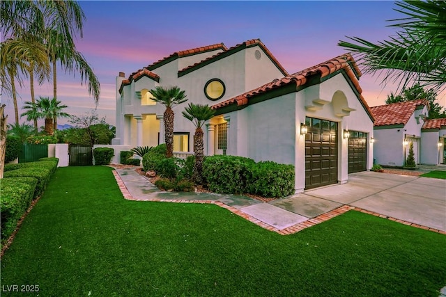 2589 Sun Reef Rd, Las Vegas, NV 89128 - mediterranean / spanish-style home featuring a tile roof, driveway, stucco siding, and a garage