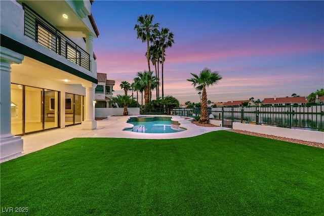 2589 Sun Reef Rd, Las Vegas, NV 89128 - pool at dusk with a patio area, a fenced backyard, and a water view