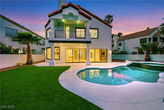 2589 Sun Reef Rd, Las Vegas, NV 89128 - back of house featuring a balcony, a fenced backyard, a patio, stucco siding, and a pool with connected hot tub