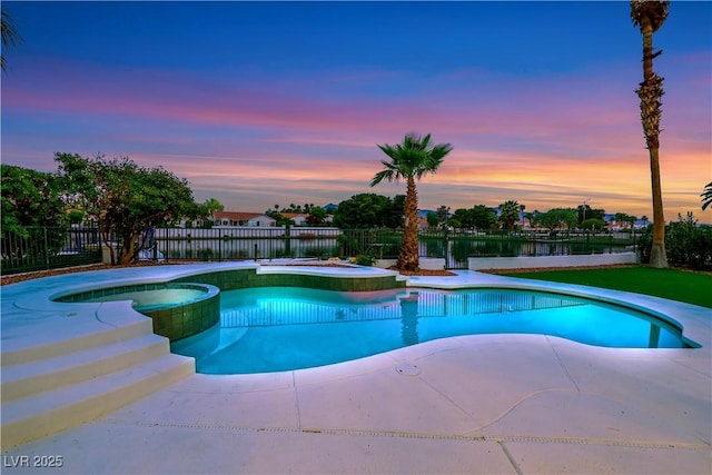 2589 Sun Reef Rd, Las Vegas, NV 89128 - pool at dusk featuring a fenced backyard, a pool with connected hot tub, a water view, and a patio