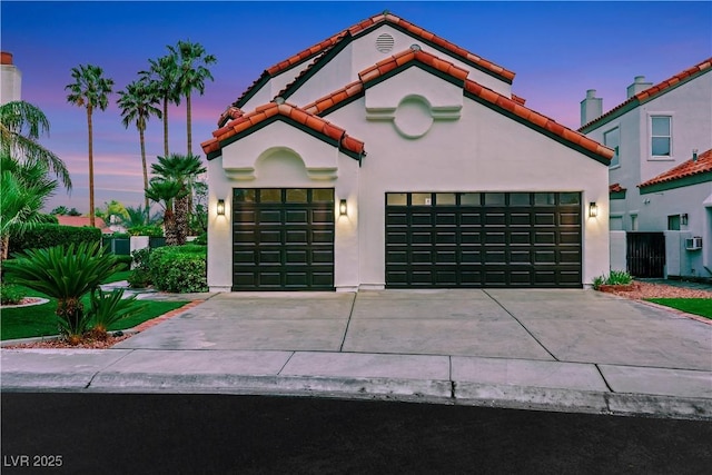 2589 Sun Reef Rd, Las Vegas, NV 89128 - mediterranean / spanish-style house with a tiled roof, a garage, concrete driveway, and stucco siding