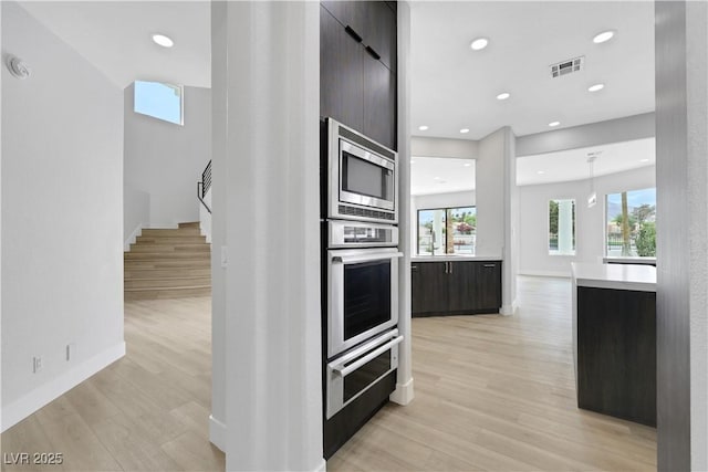 2589 Sun Reef Rd, Las Vegas, NV 89128 - kitchen featuring stainless steel appliances, modern cabinets, light countertops, light wood-style flooring, and recessed lighting
