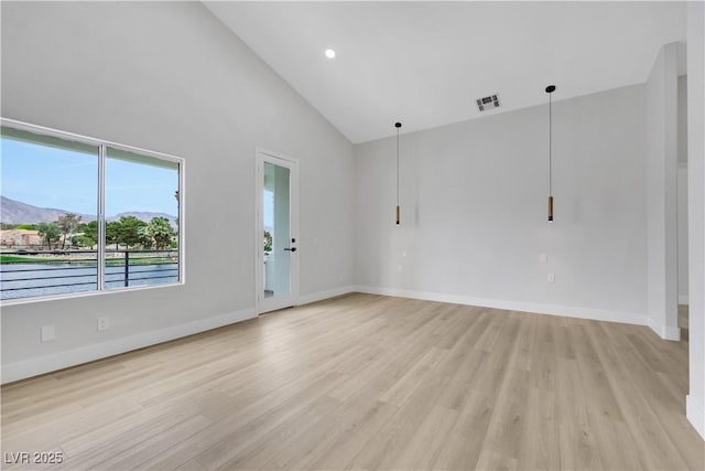 2589 Sun Reef Rd, Las Vegas, NV 89128 - spare room featuring light wood-style flooring, high vaulted ceiling, and a mountain view