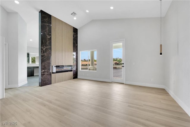 2589 Sun Reef Rd, Las Vegas, NV 89128 - unfurnished living room with high vaulted ceiling, light wood finished floors, recessed lighting, and a fireplace