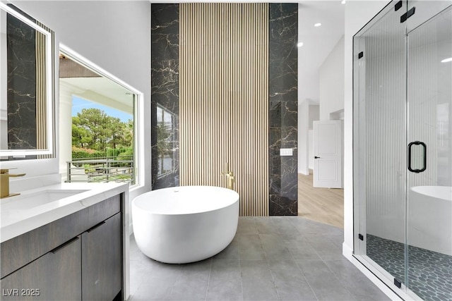 2589 Sun Reef Rd, Las Vegas, NV 89128 - full bath with vanity, a soaking tub, a stall shower, a high ceiling, and tile patterned floors