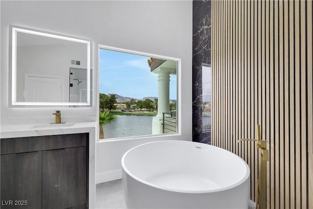 2589 Sun Reef Rd, Las Vegas, NV 89128 - full bathroom with a freestanding tub, vanity, and a water view