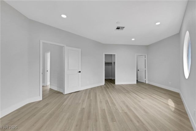 2589 Sun Reef Rd, Las Vegas, NV 89128 - unfurnished bedroom featuring light wood-style floors, recessed lighting, and a spacious closet