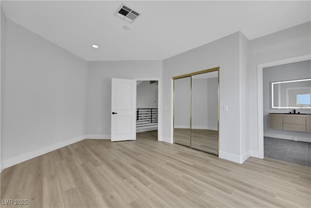 2589 Sun Reef Rd, Las Vegas, NV 89128 - unfurnished bedroom featuring light wood finished floors, a closet, and recessed lighting