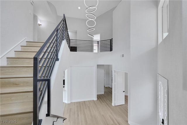2589 Sun Reef Rd, Las Vegas, NV 89128 - stairs featuring a high ceiling and wood finished floors