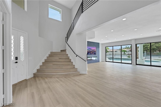 2589 Sun Reef Rd, Las Vegas, NV 89128 - foyer entrance with plenty of natural light, stairway, light wood finished floors, recessed lighting, and a towering ceiling