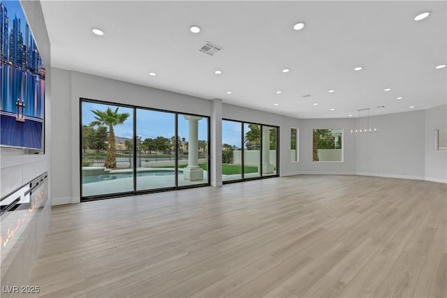2589 Sun Reef Rd, Las Vegas, NV 89128 - unfurnished living room featuring recessed lighting and light wood-style flooring